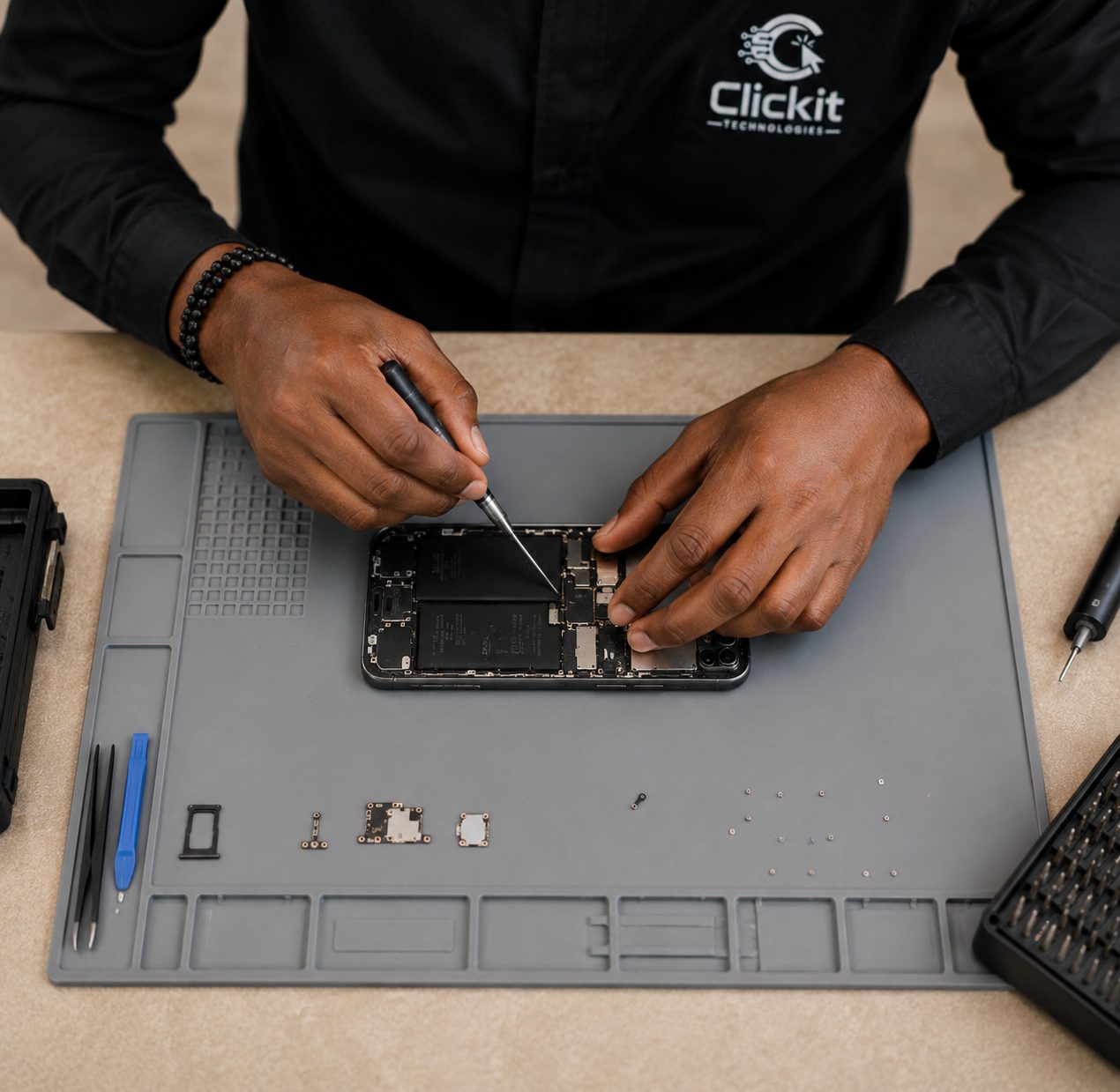 Clickit Technologies technician repairing a smartphone motherboard in Woji, Port Harcourt